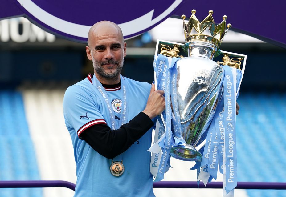 Pep Guardiola poses with the Premier League trophy (Martin Rickett/PA)