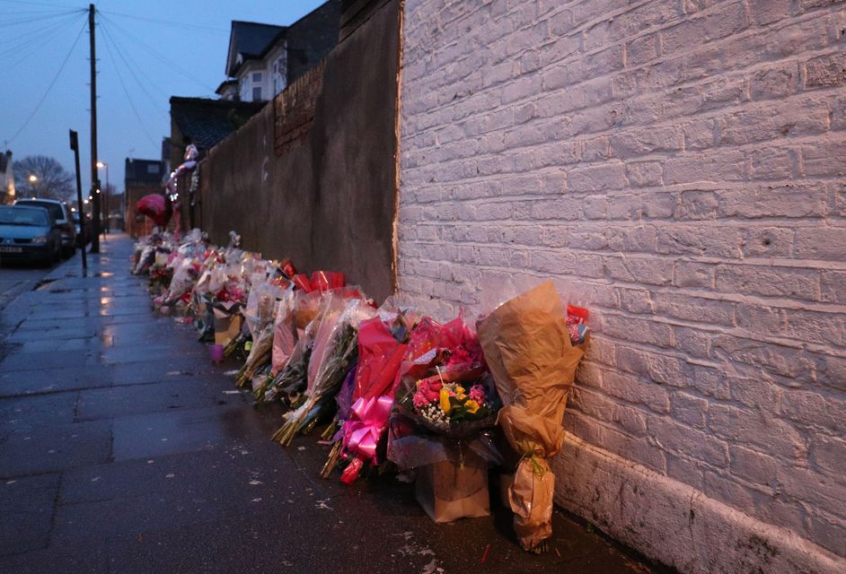 Floral tributes rest against a wall following the murder of Tanesha Melbourne-Blake in Chalgrove Road, Tottenham (Jonathan Brady/PA).