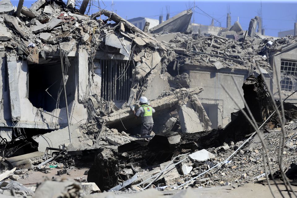 A Hezbollah rescue worker searches for victims amidst the rubble of destroyed buildings hit on Saturday night by Israeli airstrikes, in Nabatiyeh town, south Lebanon (Mohammed Zaatari/AP)