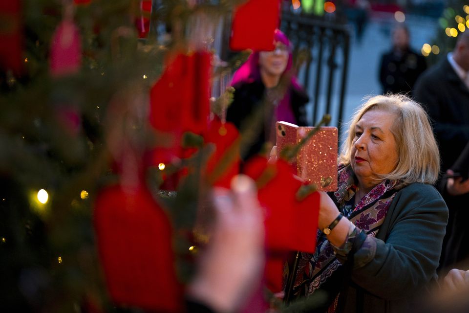 Attendees look at messages on the Kindness Tree (Jordan Pettitt/PA)