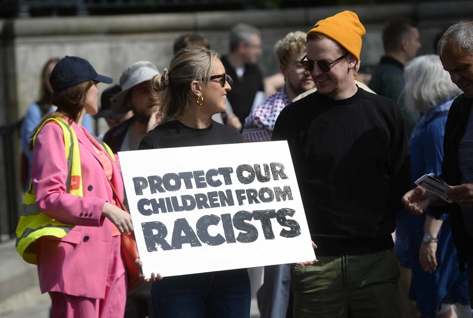 Demonstrators take part in a United Against Racism rally in Belfast (PA)