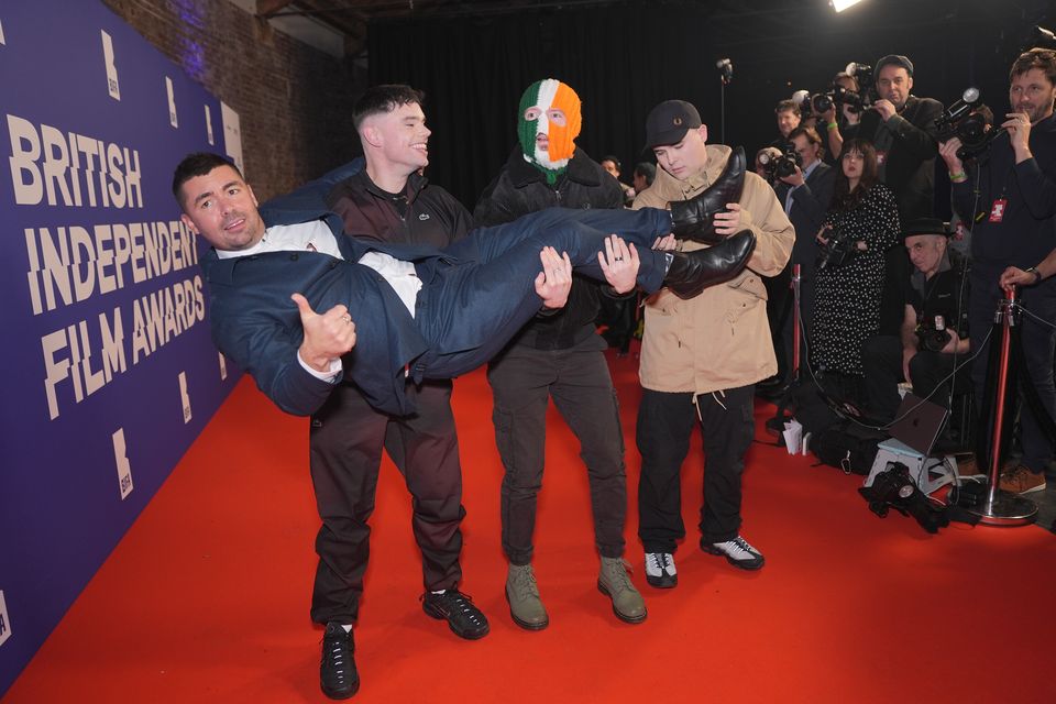 Members of Kneecap holding aloft director Rich Peppiatt attending the British Independent Film Awards ceremony at London’s Roundhouse in December (Yui Mok/PA)