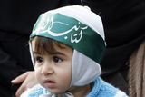 thumbnail: A Palestinian women and supporter of Hamas accompanied by a child are seen during a protest in Damascus, Syria on Saturday Dec. 27, 2008 against an Israeli raid on Gaza that killed some 145 Palestinians. Israeli warplanes attacked dozens of security compounds across Hamas-ruled Gaza on Saturday in unprecedented waves of air strikes. Gaza medics said at least 145 people were killed and more than 310 wounded in the single deadliest day in Gaza fighting in recent memory.  (AP Photo/ Bassem Tellawi).