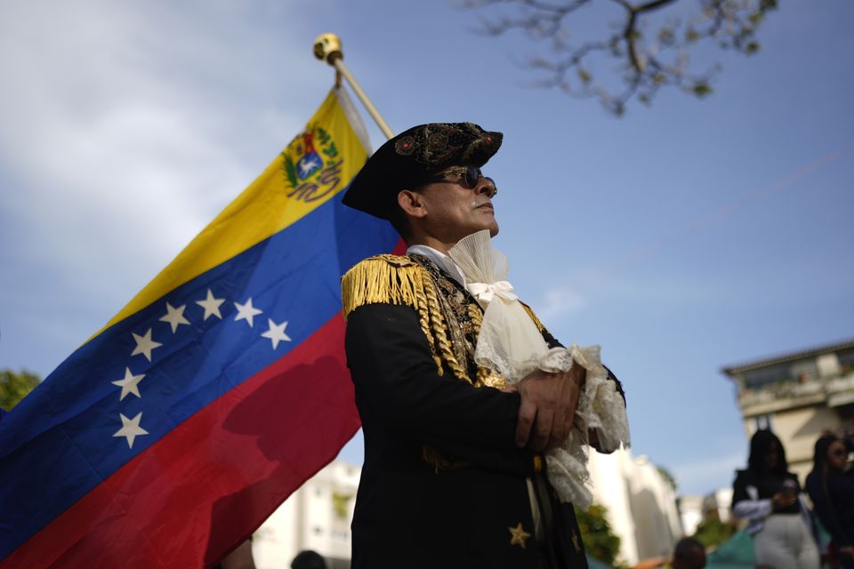 A man dressed as an Independence fighter attends a campaign event with opposition presidential candidate Edmundo Gonzalez in Caracas (Ariana Cubillos/AP)