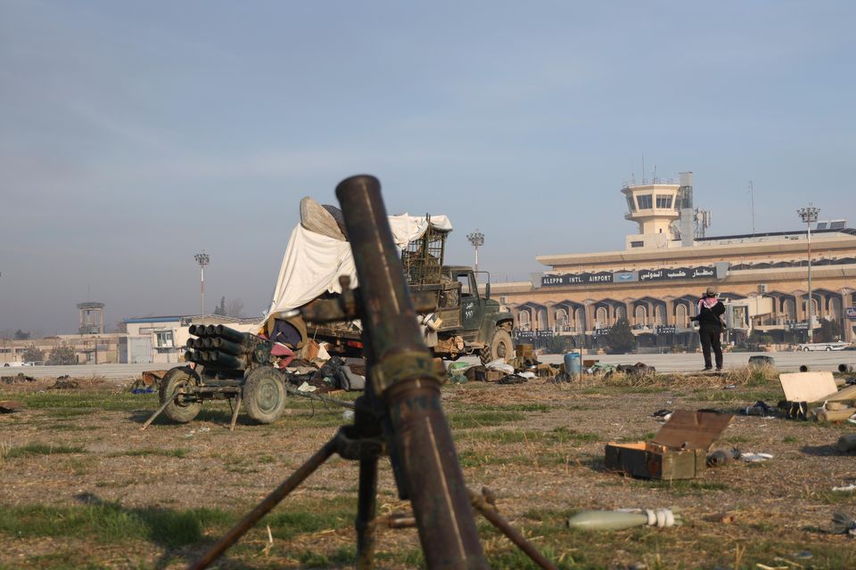 Military equipment is scattered outside Aleppo International Airport as opposition fighters take control of the facility (Omar Albam/AP)