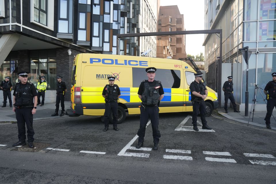 Police officers and a police van block the vehicle entrance at Liverpool Magistrates’ Court (Danny Lawson/PA)