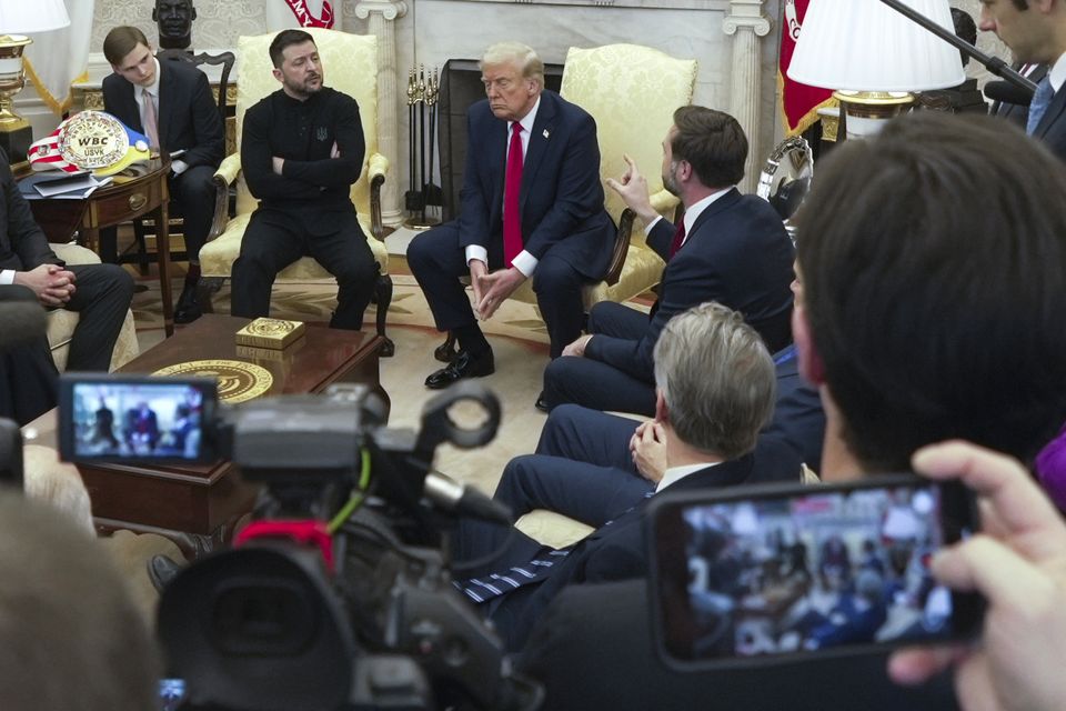 Vice President JD Vance, right, speaks with Ukrainian President Volodymyr Zelensky, left, as President Donald Trump, centre, listens in the Oval Office at the White House (AP/ Mystyslav Chernov)