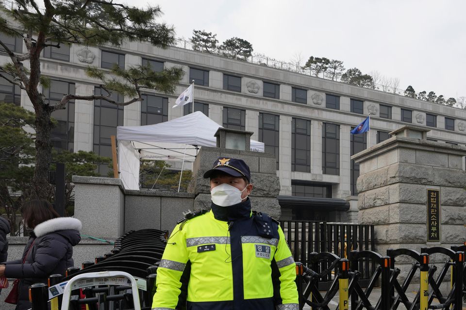 South Korean police officers stand in front of the Constitutional Court in Seoul (Lee Jin-man/AP)