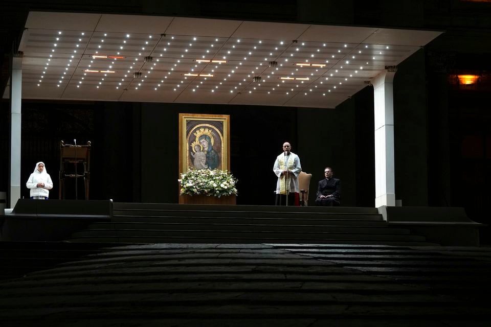 Cardinal Victor Manuel Fernandez, second right, prays during a rosary prayer for the health of Pope Francis in St Peter’s Square (Kirsty Wigglesworth/AP)