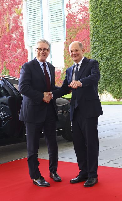 Prime Minister Sir Keir Starmer is greeted by German Chancellor, Olaf Scholz, as he arrives at the Chancellery in Berlin ahead of a quad meeting with the German Chancellor, US President Joe Biden and French President Emmanuel Macron (Nadja Wohlleben/PA)