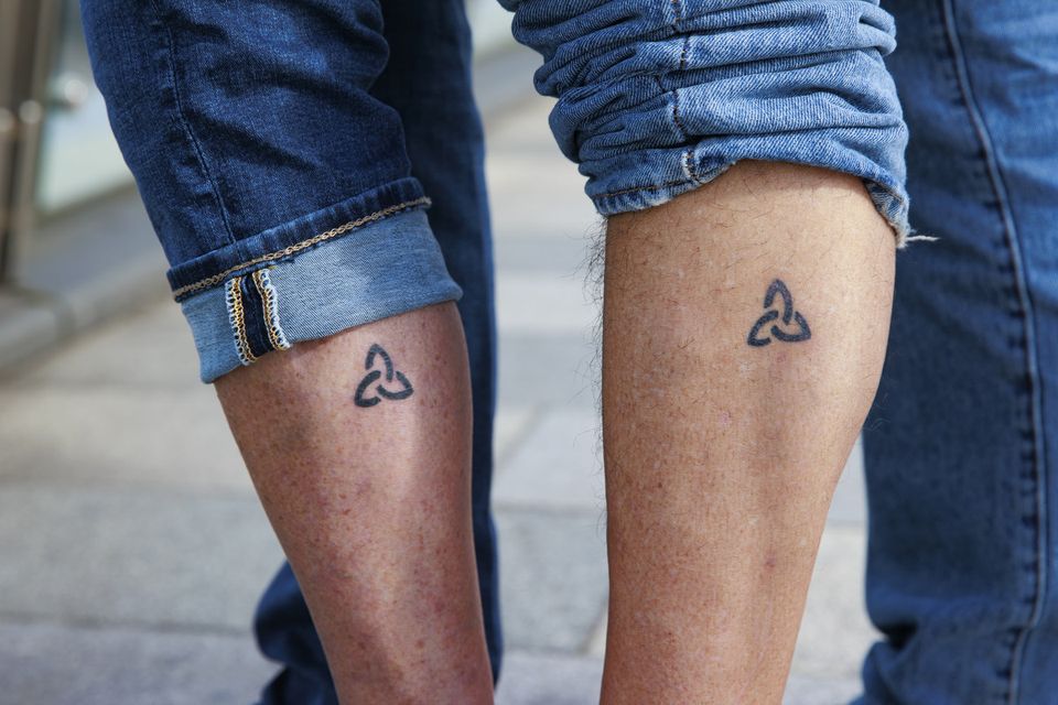 Angela Harsanyi and Gian Perroni show off their matching Trinity tattoos (Liam McBurney/PA)