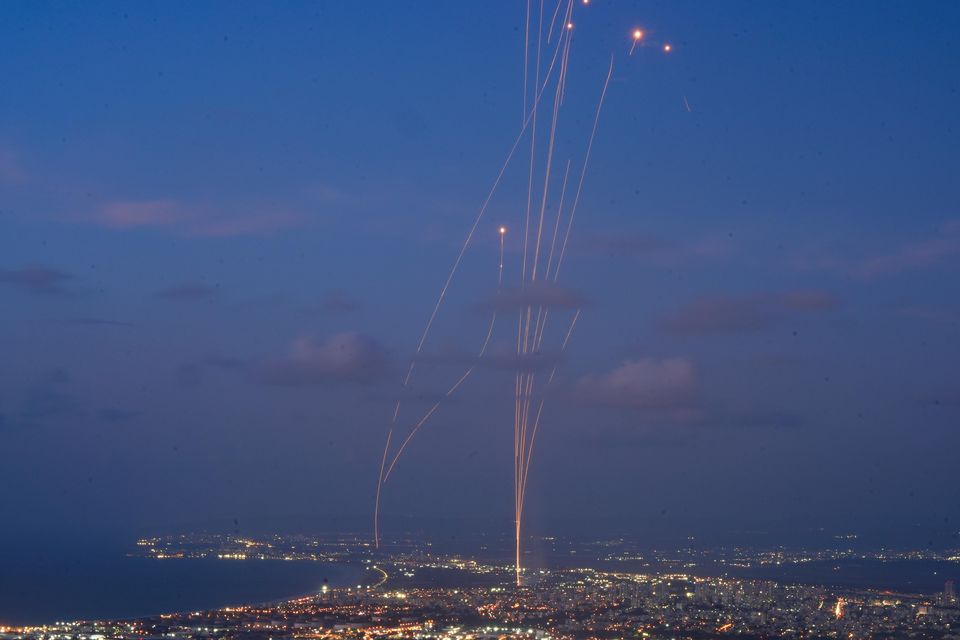 An Israeli Iron Dome air defence system fires to intercept rockets that were launched from Lebanon, as seen from Haifa, northern Israel (Baz Ratner/AP)