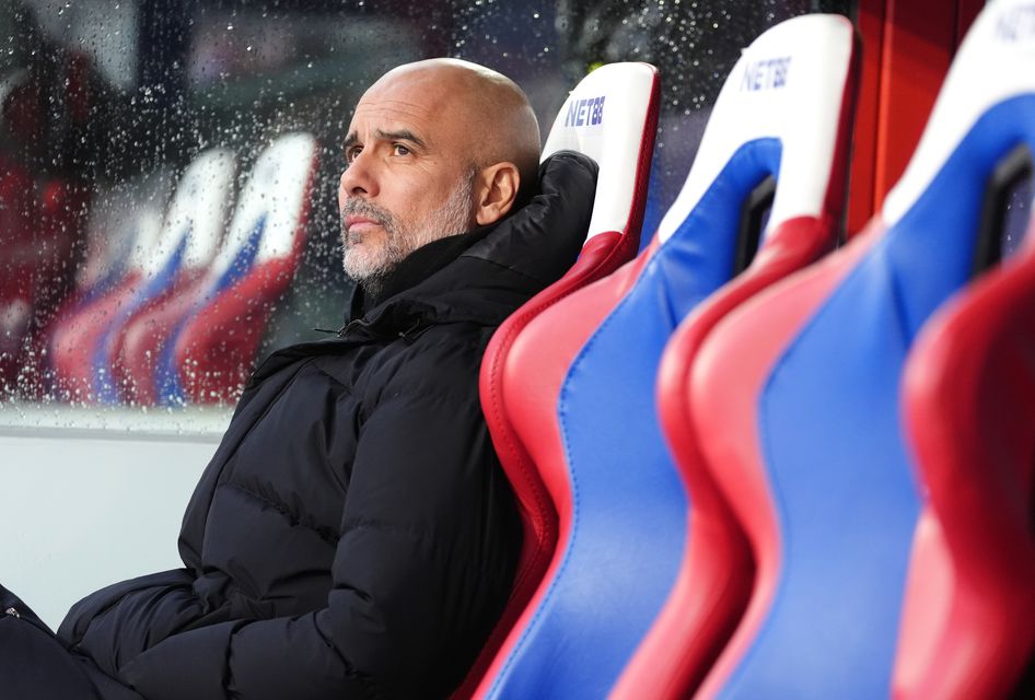 Pep Guardiola sits on the touchline at Selhurst Park (Adam Davy/PA)