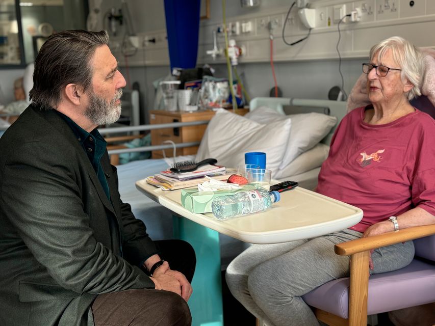 Oscar-nominated actor Ciaran Hinds speaking to patient Penny Donavan at Whiteabbey Hospital