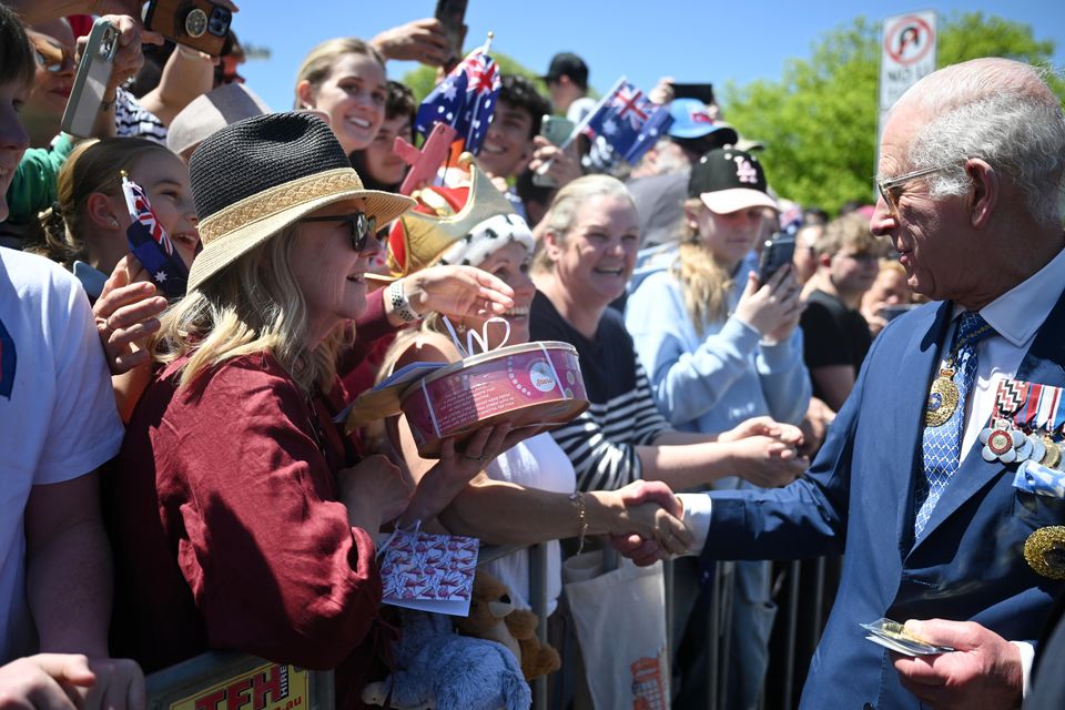 Some of the well-wishers in the crowds outside the Australian War Memorial in Canberra came bearing gifts (Victoria Jones/PA)