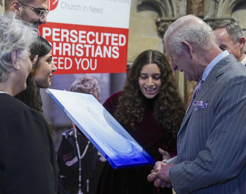 The King is presented with a painting by Sofia Butrus (Arthur Edwards/The Sun/PA)