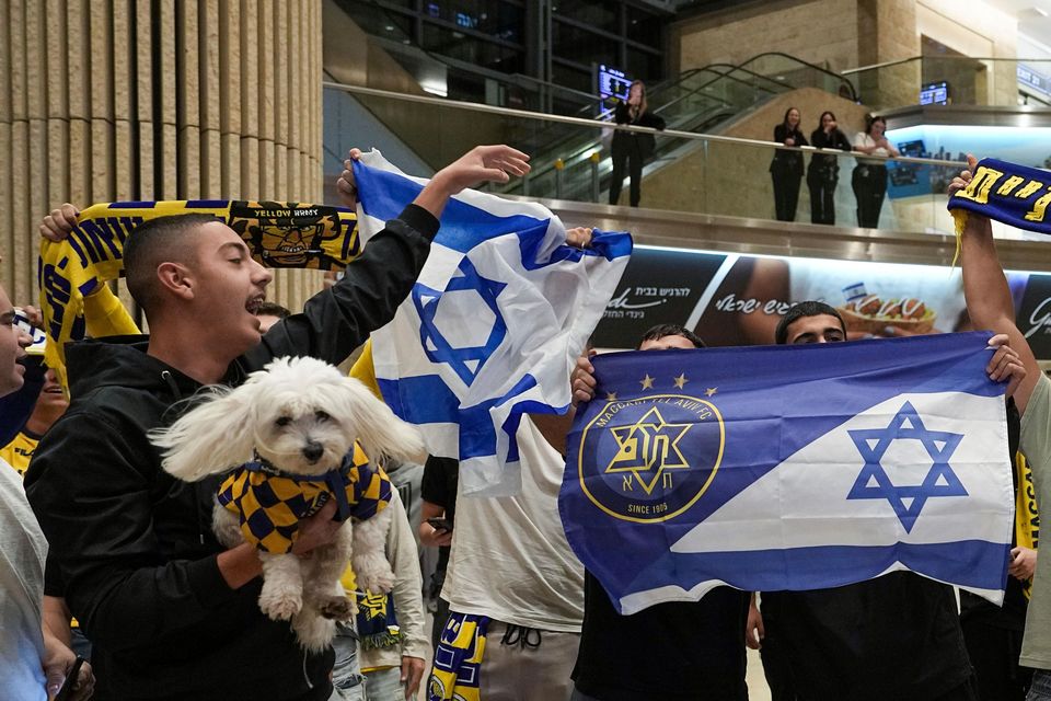 Maccabi Tel Aviv fans arrive at Israel’s Ben-Gurion International Airport (Tsafrir Abayov/AP)