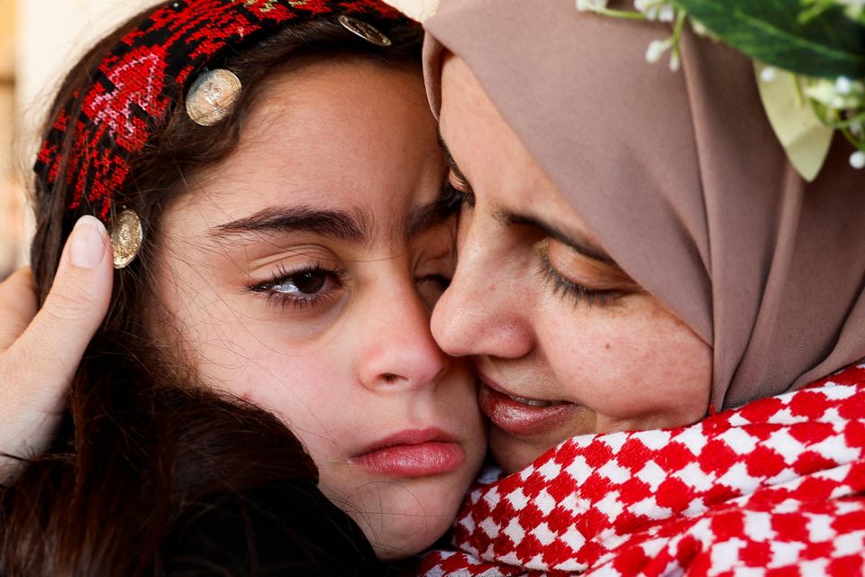 Freed Palestinian prisoner Nidaa Zaghebi embraces her daughter, Cilla, after her release from an Israeli jail as part of a hostages-prisoners swap. Photo: Raneen Sawafta/Reuters 