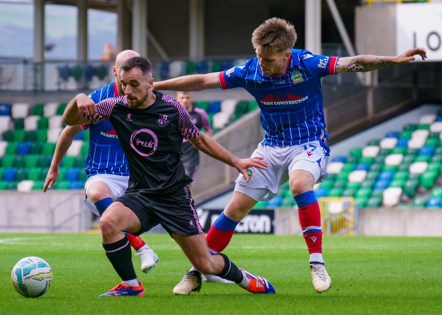 Loughgall midfielder Andrew Hoey is felled by Chris McKee