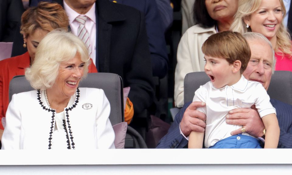 Then then-Duchess of Cornwall laughs with Prince Louis, who sits on his grandfather’s lap, during the Platinum Jubilee celebrations (Chris Jackson/PA)