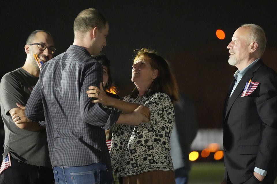 Reporter Evan Gershkovich, second left, speaks with brother-in-law Anthony Huczek, from left, sister Danielle Gershkovich, mother Ella Milman and father Mikhail Gershkovich at Andrews Air Force Base (Alex Brandon/AP)