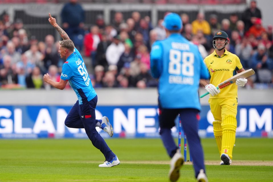 Brydon Carse, left, celebrates after removing Mitch Marsh with a beauty (Owen Humphreys/PA)