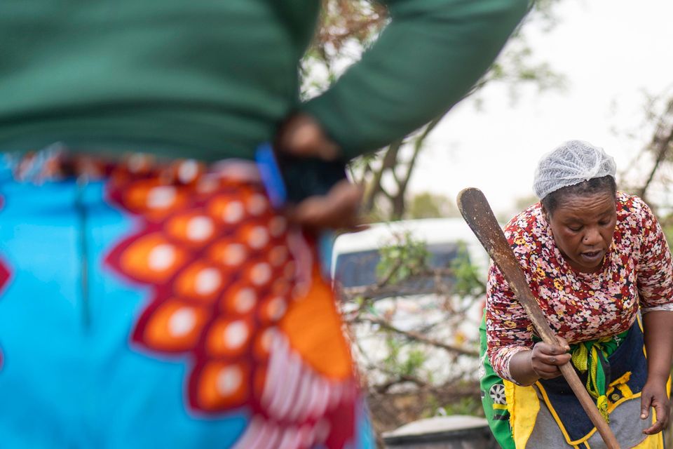 Relatives of miners and community members wait near the shaft of a closed mine where illegal miners are inside in Stilfontein, South Africa (Jerome Delay/AP)