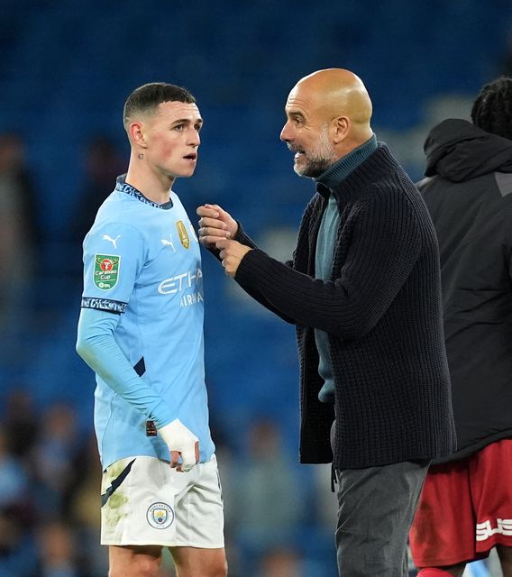 Guardiola (right) hopes Foden (left) can get back to his best (Martin Rickett/PA)