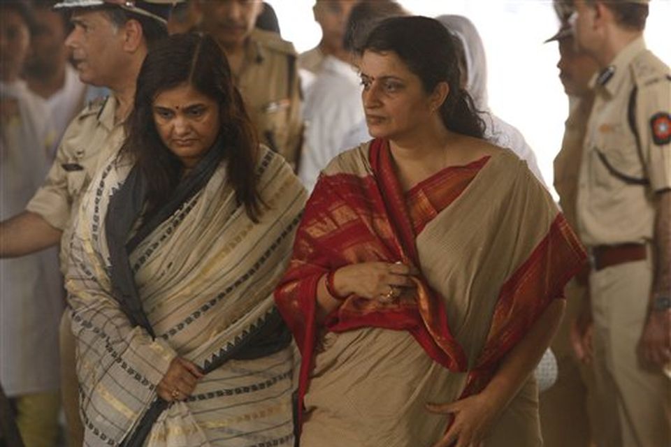 Kavita Karkare, right, wife of Hemant Karkare, the chief of Mumbai's Anti-Terrorist Squad, arrives for his funeral in Mumbai, India, Saturday, Nov. 29, 2008. Indian commandos killed the last remaining gunmen holed up at a luxury Mumbai hotel Saturday, ending a 60-hour rampage through India's financial capital by suspected Islamic militants that killed people and rocked the nation. (AP Photo/Saurabh Das)