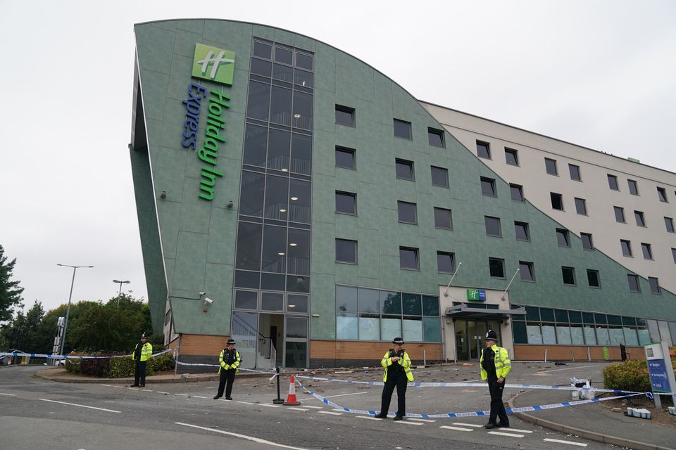 Police officers at the Holiday Inn Express in Tamworth (Jacob King/PA)