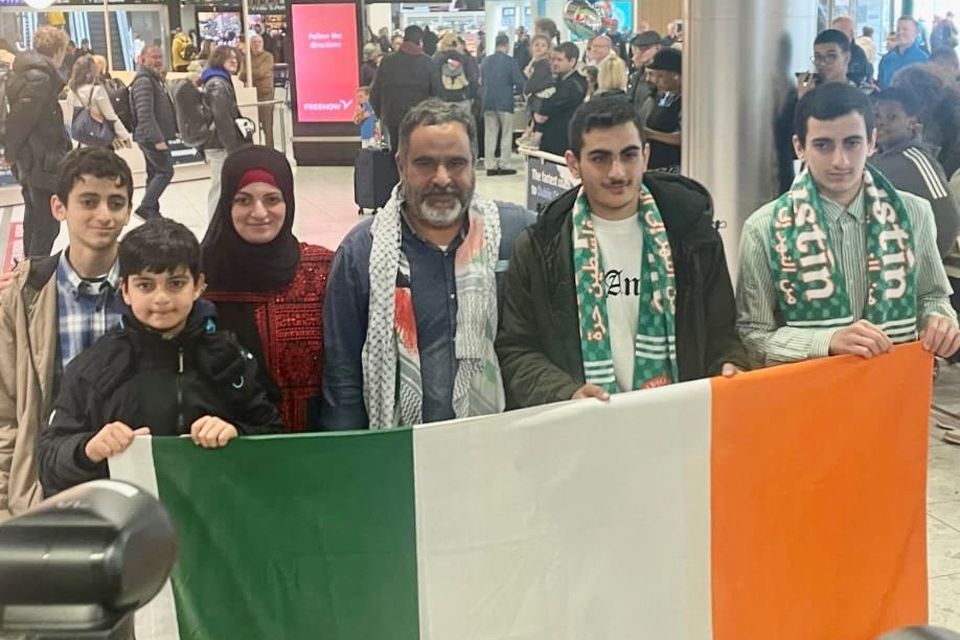 Zac Hania (centre) is reunited with his family at Dublin airport (Freda Hughes/PA)