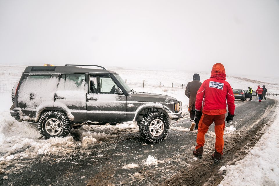 Members of a Mountain Rescue team after helping to clear cars from a snow drift near Ribblehead, in North Yorkshire (Danny Lawson/PA)