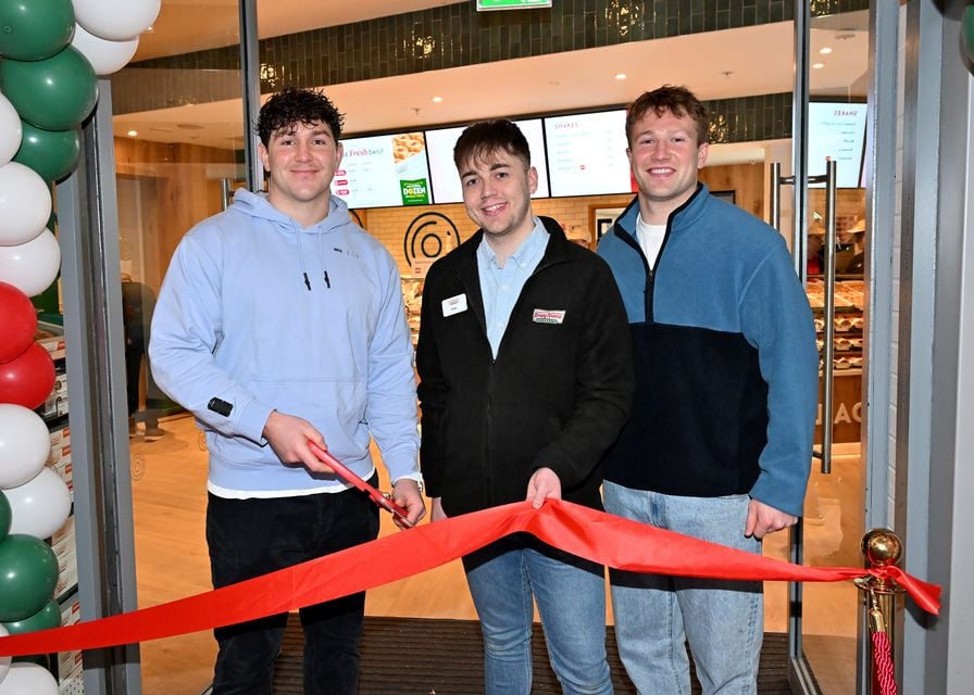 Belfast manager Sean McMullan with Ulster rugby players Stewart Moore and Tom O’Toole at the opening of Krispy Kreme in Victoria Square Belfast (Stephen Hamilton/Press Eye)