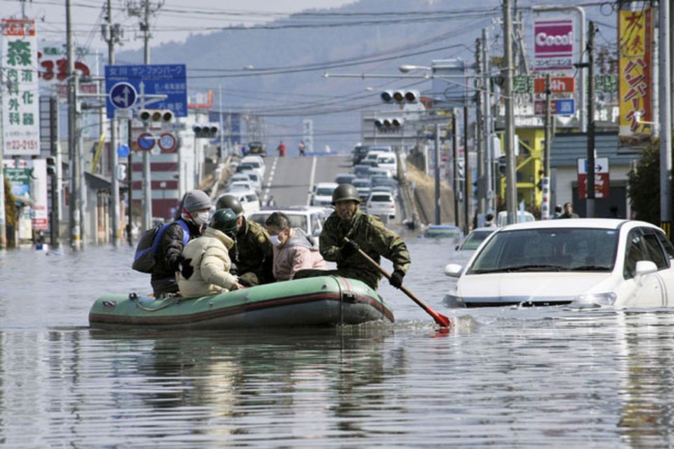 Members of Japan Self-Defense Forces rescue people stranded at a flooded city center in Ishinomaki, Miyagi Prefecture, northern Japan, Sunday, March 13, 2011, two days after a powerful earthquake-triggered tsunami hit the country's east coast. (AP Photo/Kyodo News) JAPAN OUT, MANDATORY CREDIT, NO SALES IN CHINA, HONG  KONG, JAPAN, SOUTH KOREA AND FRANCE