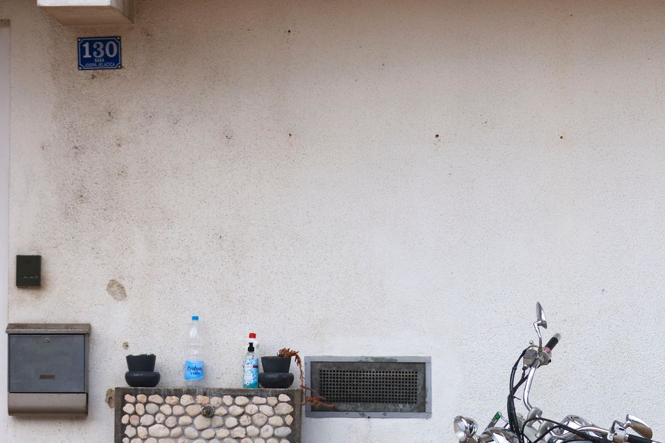 A motorcycle is partially submerged in floodwaters outside an apartment building in the village of Kiseljak, northern Bosnia (Armin Durgut/AP)