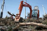 thumbnail: SENDAI, JAPAN - MARCH 14:  A worker operates a power shovel to remove trees after a 9.0 magnitude strong earthquake struck on March 11 off the coast of north-eastern Japan, on March 14, 2011 in Sendai, Japan. The quake struck offshore at 2:46pm local time, triggering a tsunami wave of up to 10 metres which engulfed large parts of north-eastern Japan. The death toll is currently unknown, with fears that the current hundreds dead may well run into thousands.  (Photo by Kiyoshi Ota/Getty Images)