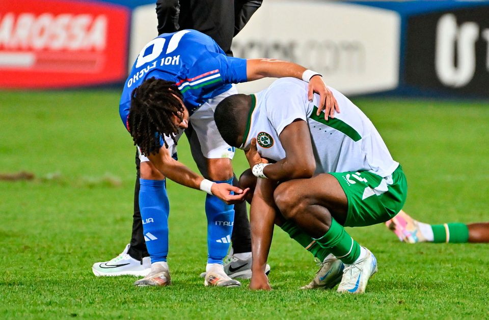 The Republic of Ireland's Sinclair Armstrong is consoled by Italy counterpart Luca Koleosho