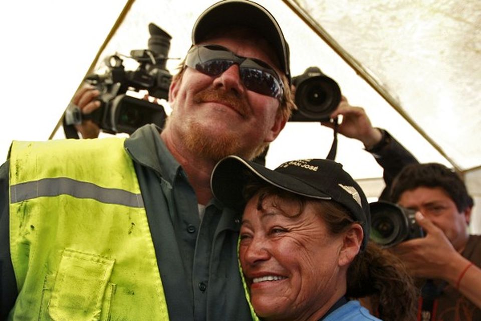 Drill operator Jeff Hart embraces Elizabeth Segovia, sister of trapped miner Dario Segovia Rojo, at the San Jose mine near Copiapo, Chile (AP)