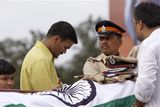 thumbnail: His uniform is placed on his body as Hemant Karkare, the chief of Mumbai's Anti-Terrorist Squad is taken for cremation in Mumbai, India, Saturday, Nov. 29, 2008. Indian commandos killed the last remaining gunmen holed up at a luxury Mumbai hotel Saturday, ending a 60-hour rampage through India's financial capital by suspected Islamic militants that rocked the nation. (AP Photo/Saurabh Das)