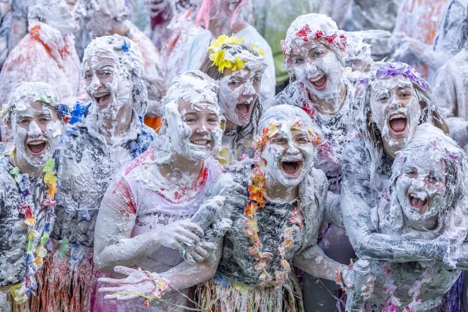 Some students donned floral headdresses and grass skirts before being covered in shaving foam (Jane Barlow/PA)