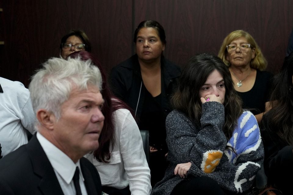 Dalma, centre, and Yanina Maradona, daughters of late soccer star Diego Maradona, sit in court on the first day of the trial (Natacha Pisarenko/AP)