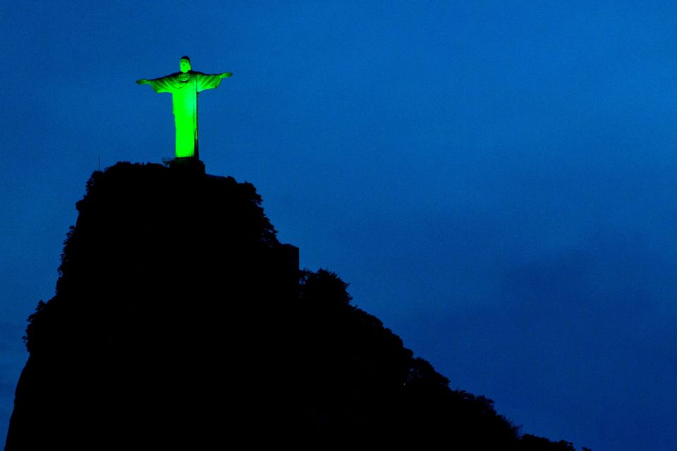 Christ the Redeemer illuminated in green to celebrate the upcoming Irish festivity of Saint Patrick's Day, atop Corcovado hill in Rio de Janeiro, Brazil, on March 15, 2015.   AFP PHOTO / YASUYOSHI CHIBAYASUYOSHI CHIBA/AFP/Getty Images