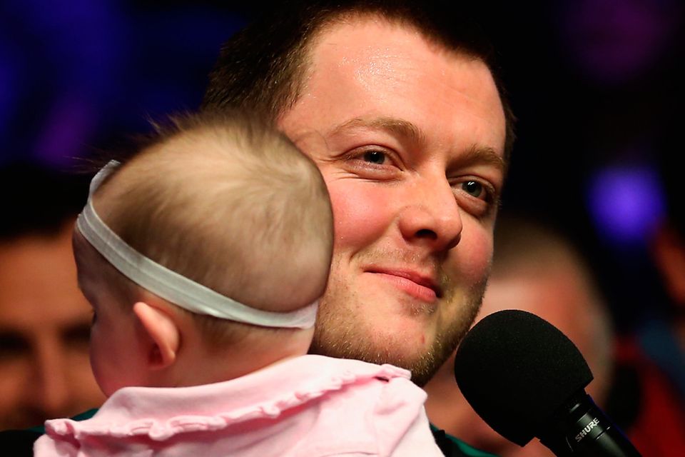 Mark Allen holds his daughter as he celebrates victory following The Dafabet Master Final between Kyren Wilson and Mark Allen at Alexandra Palace on January 21, 2018 in London, England.  (Photo by Alex Pantling/Gett