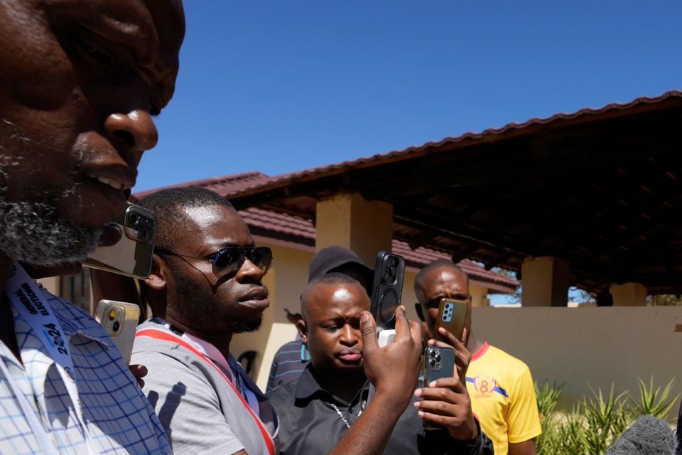 Umbrella for Democratic Change (UDC) presidential candidate Duma Boko speaks to journalist after casting his vote during the elections in Gaborone (Themba Hadebe/AP)