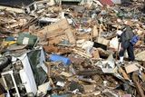thumbnail: A parent and child react as they search for missing relatives through debris caused by Friday's massive earthquake and the ensuing tsunami, in Kamaishi, northern Japan Sunday, March 13, 2011. (AP Photo/Asahi Shimbun, Toshiyuki Hayashi) JAPAN OUT, NO SALES, MANDATORY CREDIT