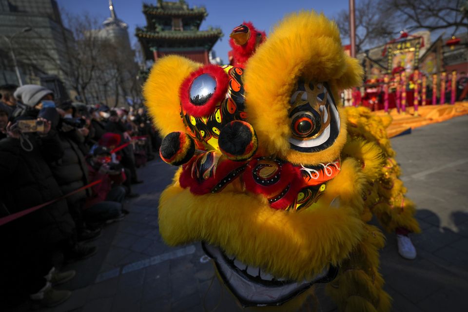 Traditionally, Chinese people have a family dinner at home on New Year’s Eve and visit ‘temple fairs’ on the Lunar New Year to watch performances and buy snacks, toys and other trinkets from booths (AP)