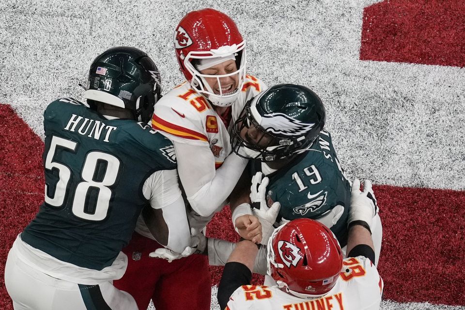 Kansas City Chiefs quarterback Patrick Mahomes is hit by Philadelphia Eagles linebackers Jalyx Hunt and Josh Sweat (David J Phillip)