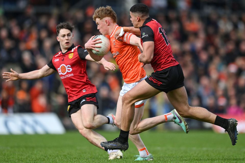 Conor Turbitt of Armagh in action against Ceilum Doherty, left, and Finn McElroy of Down