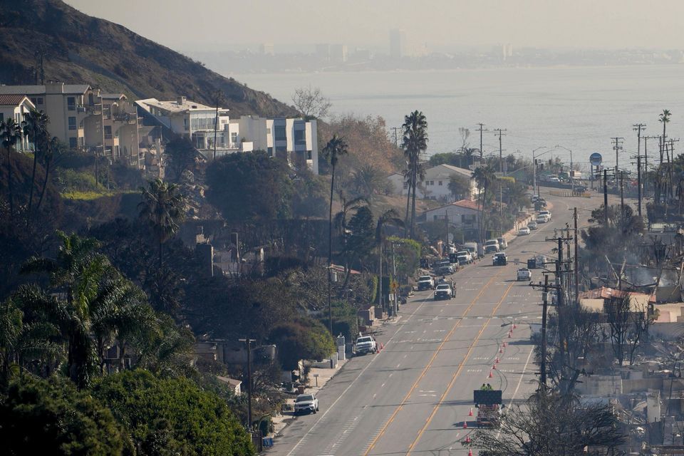 Beach-front properties smouldering in the aftermath of the Palisades fire on Friday (John Locher/AP)