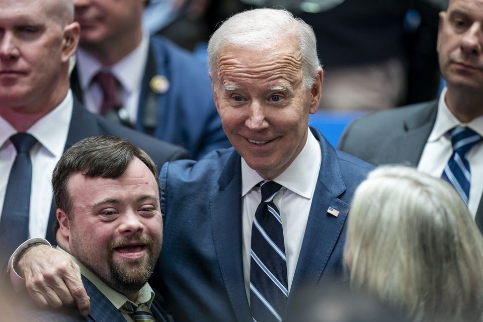 US President Joe Biden embraces James Martin, who starred in the Oscar winning short film An Irish Goodbye, as he visits Ulster University in Belfast (Aaron Chown/PA)